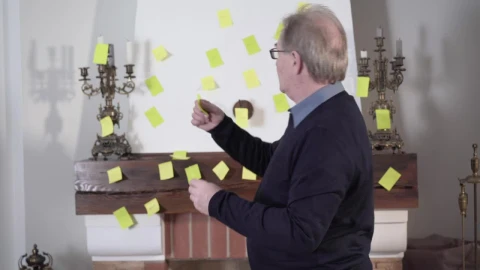 Stock Video Old Man Placing Notes On The Wall For His Memory Live Wallpaper - Free Live Wallpaper