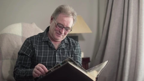 Stock Video Old Man Remembering With His Photo Album Live Wallpaper - Free Live Wallpaper