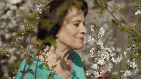 Stock Video Old Woman Smelling Flowers From Her Garden Live Wallpaper - Free Live Wallpaper