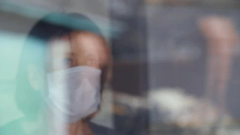 Stock Video Old Woman With Mask Looks Out The Window Live Wallpaper - Free Live Wallpaper