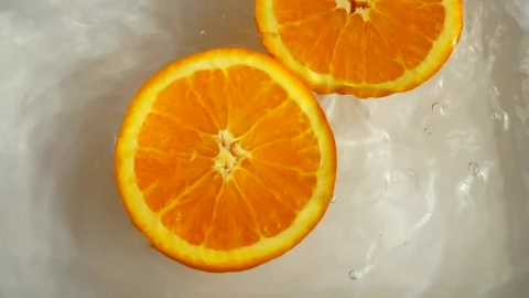 Stock Video Orange Half Spinning While Floating In Water Live Wallpaper - Free Live Wallpaper