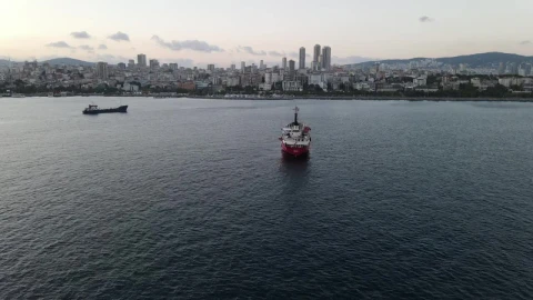 Stock Video Pair Of Cargo Ships Sailing Near A Coastal Town Live Wallpaper - Free Live Wallpaper