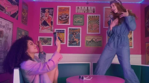 Stock Video Pair Of Female Friends Having Fun In A Retro Restaurant Live Wallpaper - Free Live Wallpaper