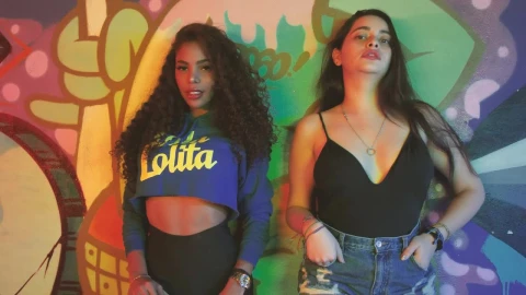 Stock Video Pair Of Girls Leaning Against A Wall With Graffiti Live Wallpaper - Free Live Wallpaper
