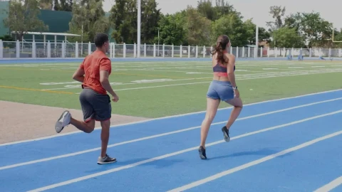 Stock Video Pair Of Man And Woman Athletes Running On A Track Live Wallpaper - Free Live Wallpaper