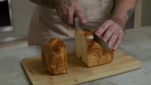 Stock Video Pastry Chef Cutting A Loaf Into Slices Live Wallpaper - Free Live Wallpaper
