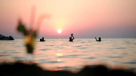 Stock Video People Playing Ball In The Ocean At Sunset Live Wallpaper - Free Live Wallpaper