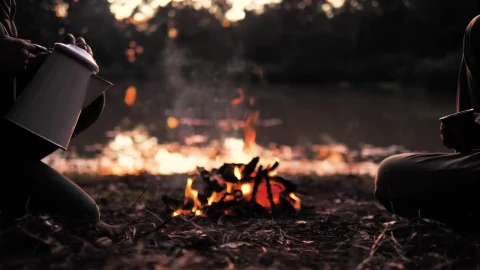 Stock Video People Pouring A Warm Drink Around A Campfire Live Wallpaper - Free Live Wallpaper