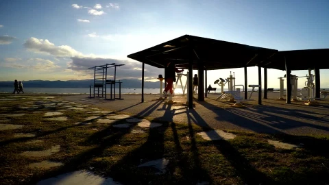 Stock Video People Working Out On The Beach At An Outdoor Gym Live Wallpaper - Free Live Wallpaper
