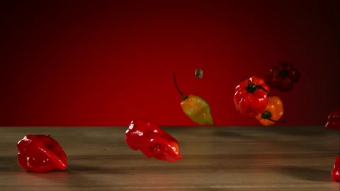 Stock Video Peppers Falling And Bouncing On A Wooden Table Live Wallpaper - Free Live Wallpaper