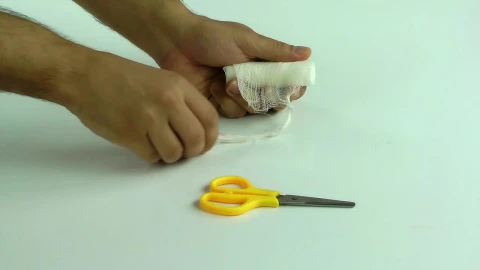 Stock Video Person Bandaging Himself The Hurt Hand Live Wallpaper - Free Live Wallpaper
