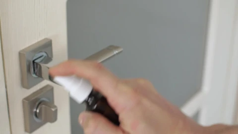 Stock Video Person Disinfecting A Door With Spray Live Wallpaper - Free Live Wallpaper