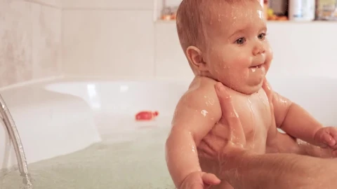 Stock Video Person Holding Baby In Bathtub With Both Hands Live Wallpaper - Free Live Wallpaper