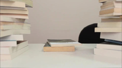 Video Stock Person Sits Down To Read Surrounded By Many Books Live Wallpaper Free - Free Live Wallpaper
