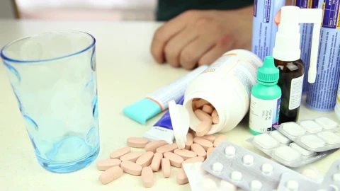 Video Stock Person Taking A Pill Among Other Drugs Live Wallpaper Free - Free Live Wallpaper