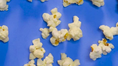Video Stock Popcorn Scattered In Stop Motion On A Blue Background Live Wallpaper Free - Free Live Wallpaper