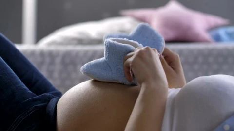 Video Stock Pregnant Woman Playing With Baby Shoes Live Wallpaper Free - Free Live Wallpaper