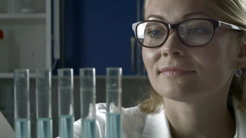 Free Stock Video Researcher Adding Blue Liquid To Test Tubes Live Wallpaper - Free Live Wallpaper