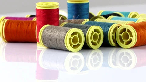 Free Stock Video Rolls Of Thread On A Reflective White Table Live Wallpaper - Free Live Wallpaper