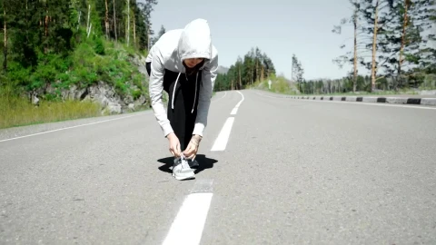 Free Stock Video Runner Ties Laces Before Starting Jog On Mountain Road Live Wallpaper - Free Live Wallpaper