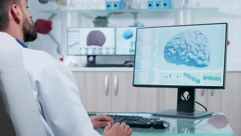 Free Stock Video Scientist Looks At D Brain Model On Computer Screen Live Wallpaper - Free Live Wallpaper