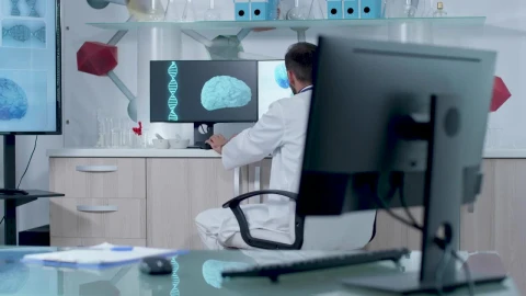 Free Stock Video Scientist Typing In Front Of Dna Models In Modern Lab Live Wallpaper - Free Live Wallpaper