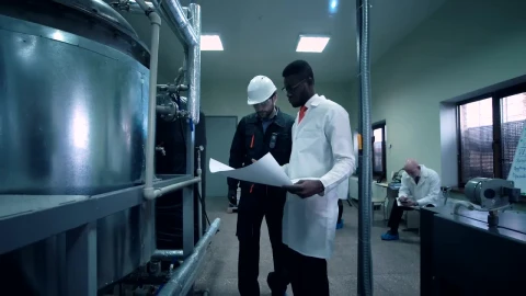 Free Stock Video Scientist Walking Through Lab With A Blueprint Live Wallpaper - Free Live Wallpaper