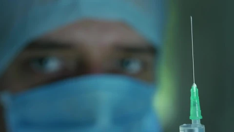 Free Stock Video Shallow Focus Of A Doctor Looking At The Syringe Live Wallpaper - Free Live Wallpaper