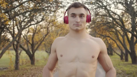 Free Stock Video Shirtless Man In Headphones Flexes Muscles Before Outdoor Workout Live Wallpaper - Free Live Wallpaper
