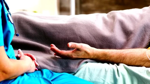 Free Stock Video Sick Man On Bed Comforted By Nurse Holding Hands Live Wallpaper - Free Live Wallpaper
