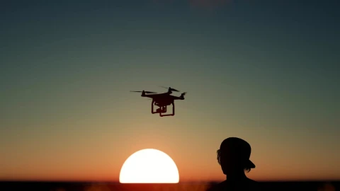 Free Stock Video Silhouette Of A Boy Flying A Drone At Sunset Live Wallpaper - Free Live Wallpaper