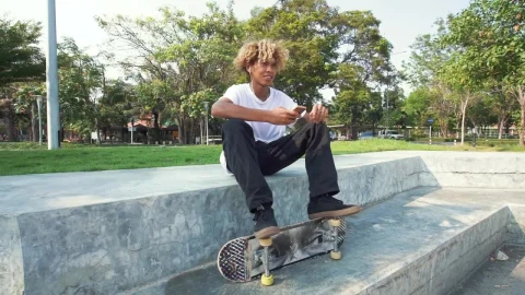 Free Video Stock Skater Sitting In A Park Listening To Music Live Wallpaper - Free Live Wallpaper