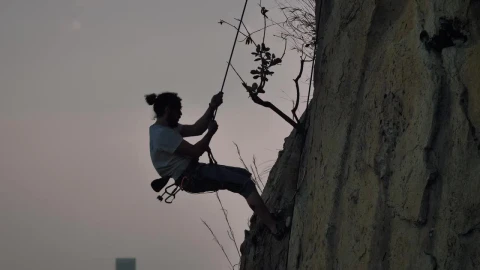 Free Video Stock Skilled Mountaineer Descending From A Mountain With A Rope Live Wallpaper - Free Live Wallpaper