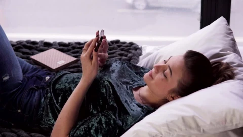 Free Video Stock Smiling While Browsing Her Phone Live Wallpaper - Free Live Wallpaper