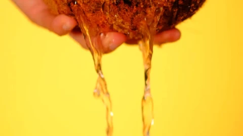 Free Video Stock Spilling Water From A Coconut On A Yellow Background Live Wallpaper - Free Live Wallpaper