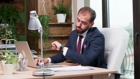 Free Video Stock Stressed Man In Suit Yawns And Types On Laptop Live Wallpaper - Free Live Wallpaper