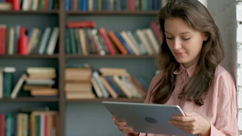 Free Video Stock Student Reading On A Tablet At A Library Live Wallpaper - Free Live Wallpaper