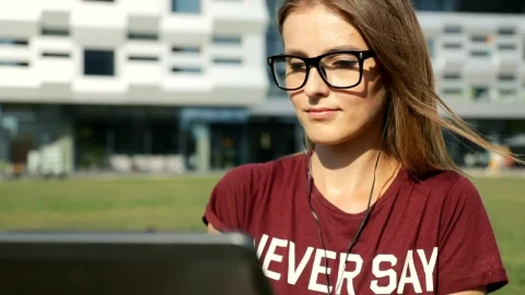 Free Video Stock Student Sitting Outside University With Laptop Live Wallpaper - Free Live Wallpaper