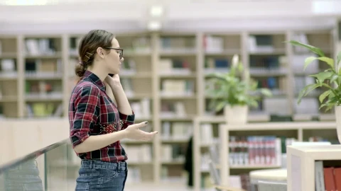 Free Video Stock Student Woman Talking On The Phone In The Library Live Wallpaper - Free Live Wallpaper