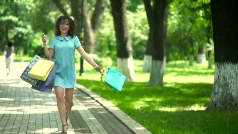 Free Video Stock Stylish Woman Spins With Shopping Bags On Sunny Parkway Live Wallpaper - Free Live Wallpaper