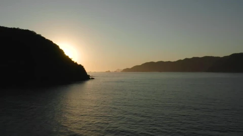 Free Video Stock sunset seen at sea from a coast aerial shot Live Wallpaper - Free Live Wallpaper