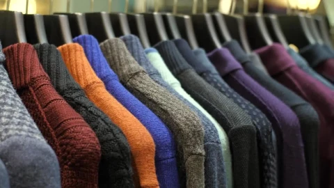 Free Video Stock sweaters hanging on the coat rack of a clothing store Live Wallpaper - Free Live Wallpaper