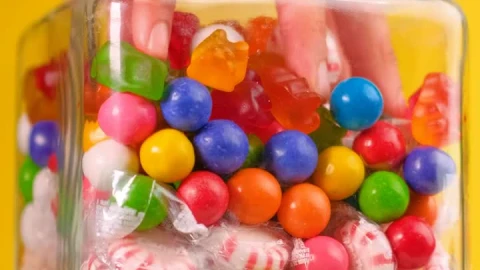 Free Video Stock taking candy from a pot that is on a yellow Live Wallpaper - Free Live Wallpaper