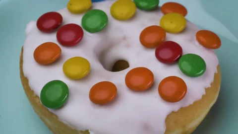 Free Video Stock taking glazed donut with colored chocolates from a plate Live Wallpaper - Free Live Wallpaper