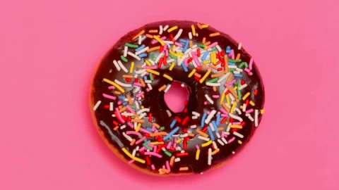 Free Video Stock taking three glazed donuts in a row on a pink Live Wallpaper - Free Live Wallpaper