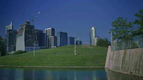 Free Video Stock tall buildings surrounding a natural park in a city Live Wallpaper - Free Live Wallpaper