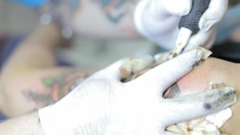 Free Video Stock tattoo artist tattooing a colored flower Live Wallpaper - Free Live Wallpaper