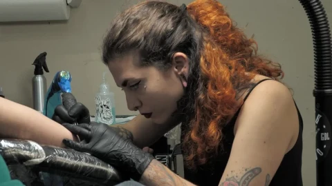Free Video Stock tattoo artist working on a customer Live Wallpaper - Free Live Wallpaper