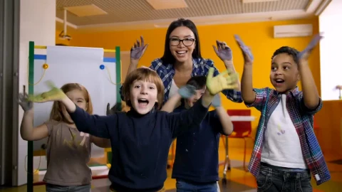 Free Video Stock teacher and students waving with painted hands Live Wallpaper - Free Live Wallpaper