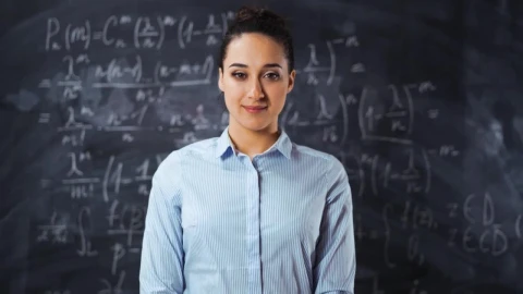 Free Video Stock teacher smiling in front of a blackboard Live Wallpaper - Free Live Wallpaper